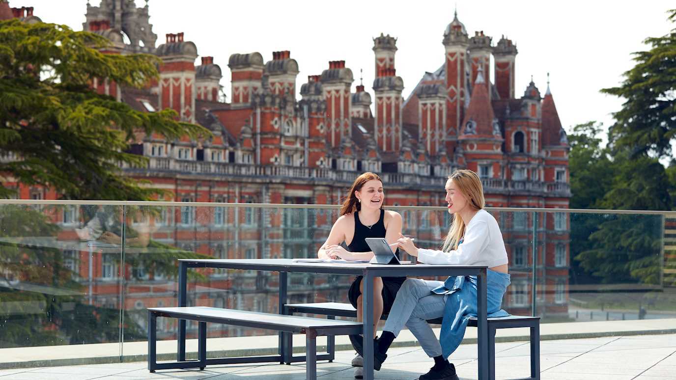 Students sitting on roof of Davison Building opposite Founder's